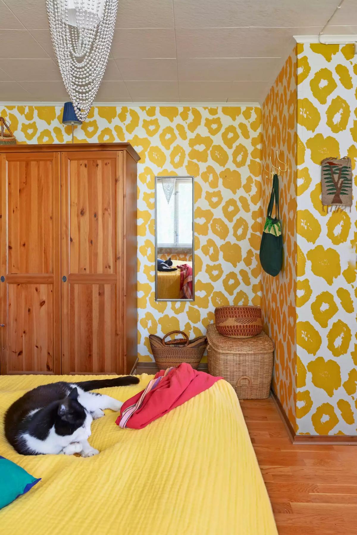 A cat lying on the bed in the bedroom