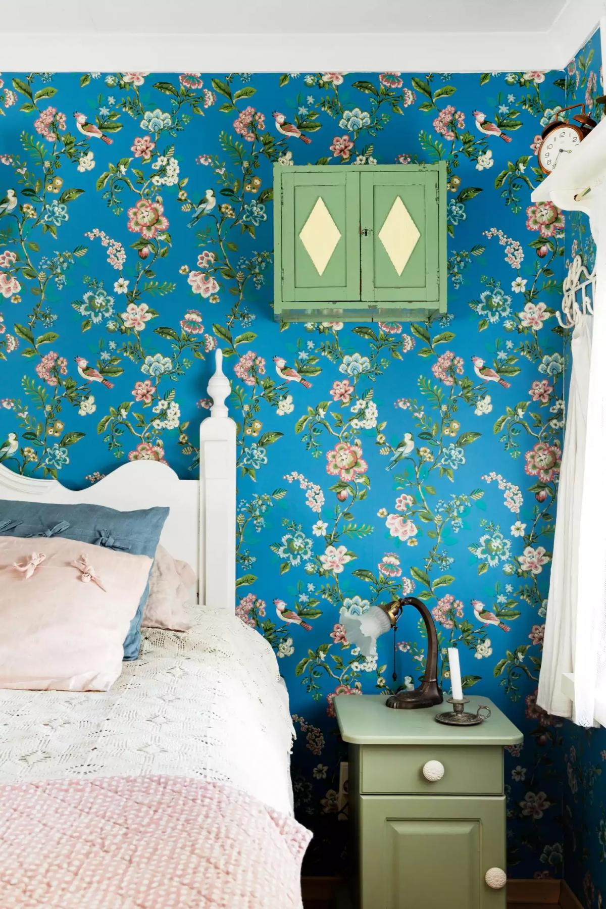 Bedroom with blue floral wallpaper