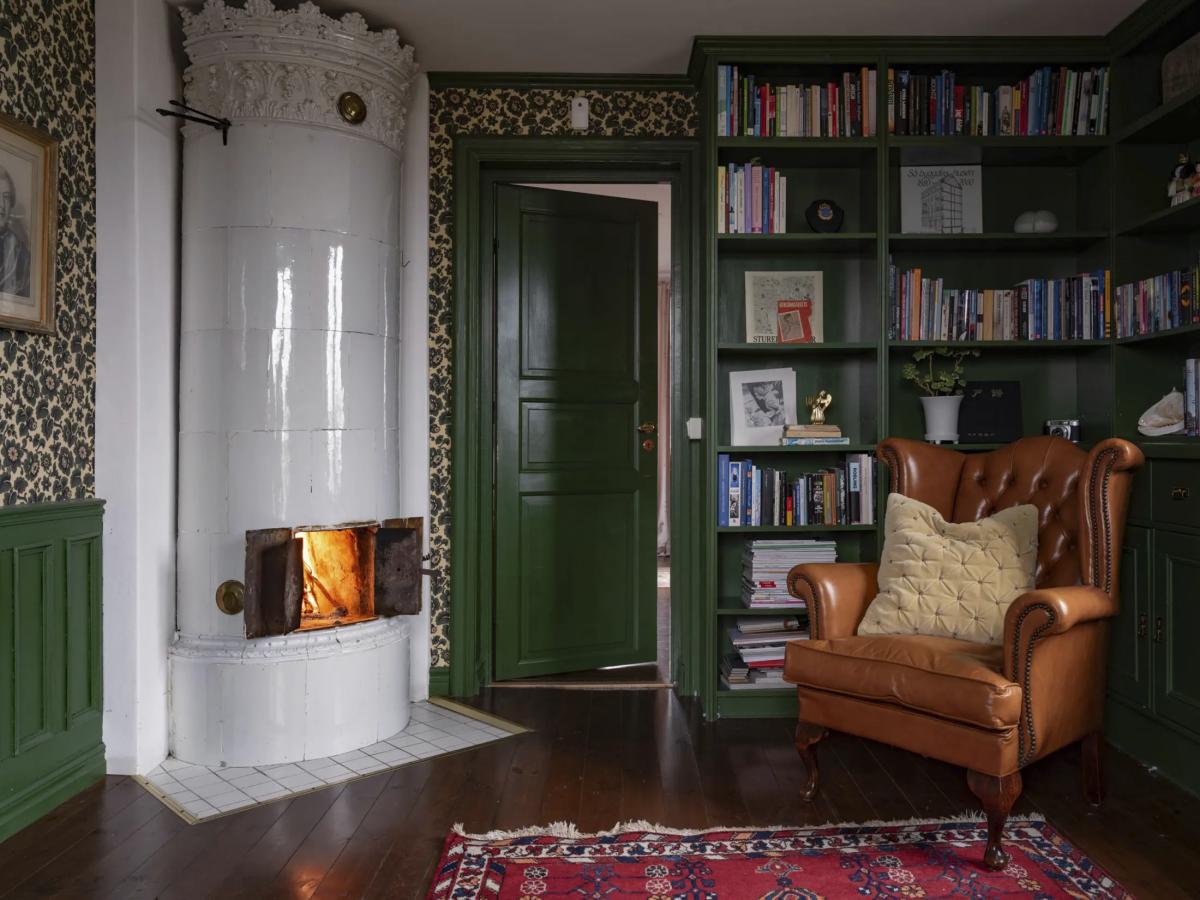 Home library with a stove and vintage armchair