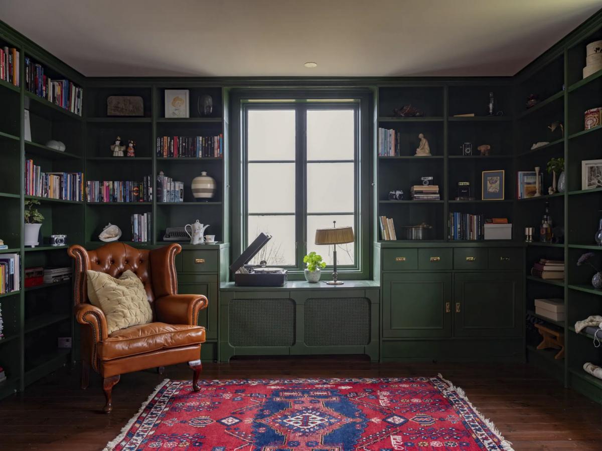 Home library with a leather armchair in a Swedish house