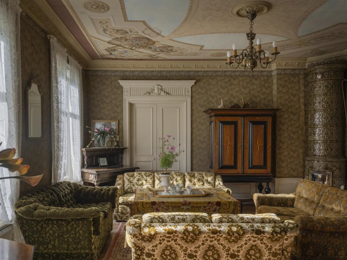 Four sofas in the living room of a Swedish mansion