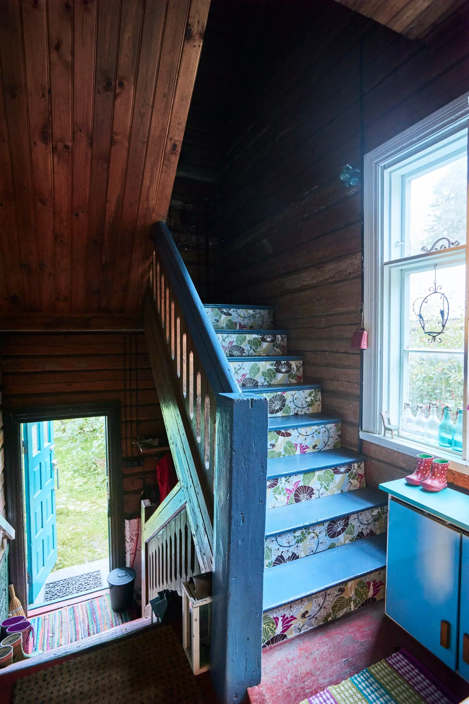 Blue staircase decorated with old wallpaper