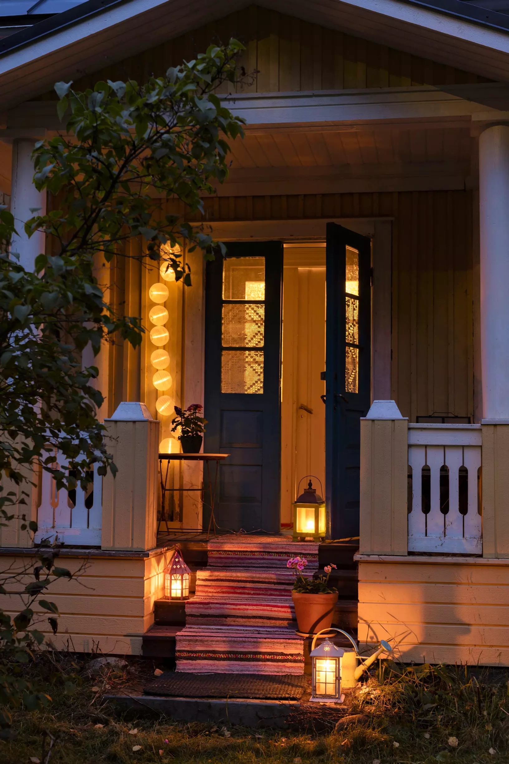 The doorstep of the house in the evening with floor lamps