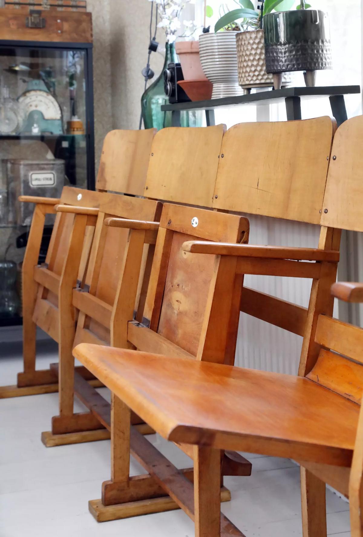 Wooden cinema chairs repurposed in the house